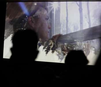 film still of woman looking out the window