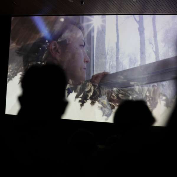 film still of woman looking out the window