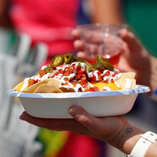 bowl of nachos with jalapenos on top bowl of nachos with jalapenos on top