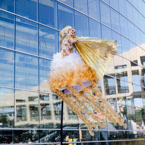 woman in flowing costume soaring through air